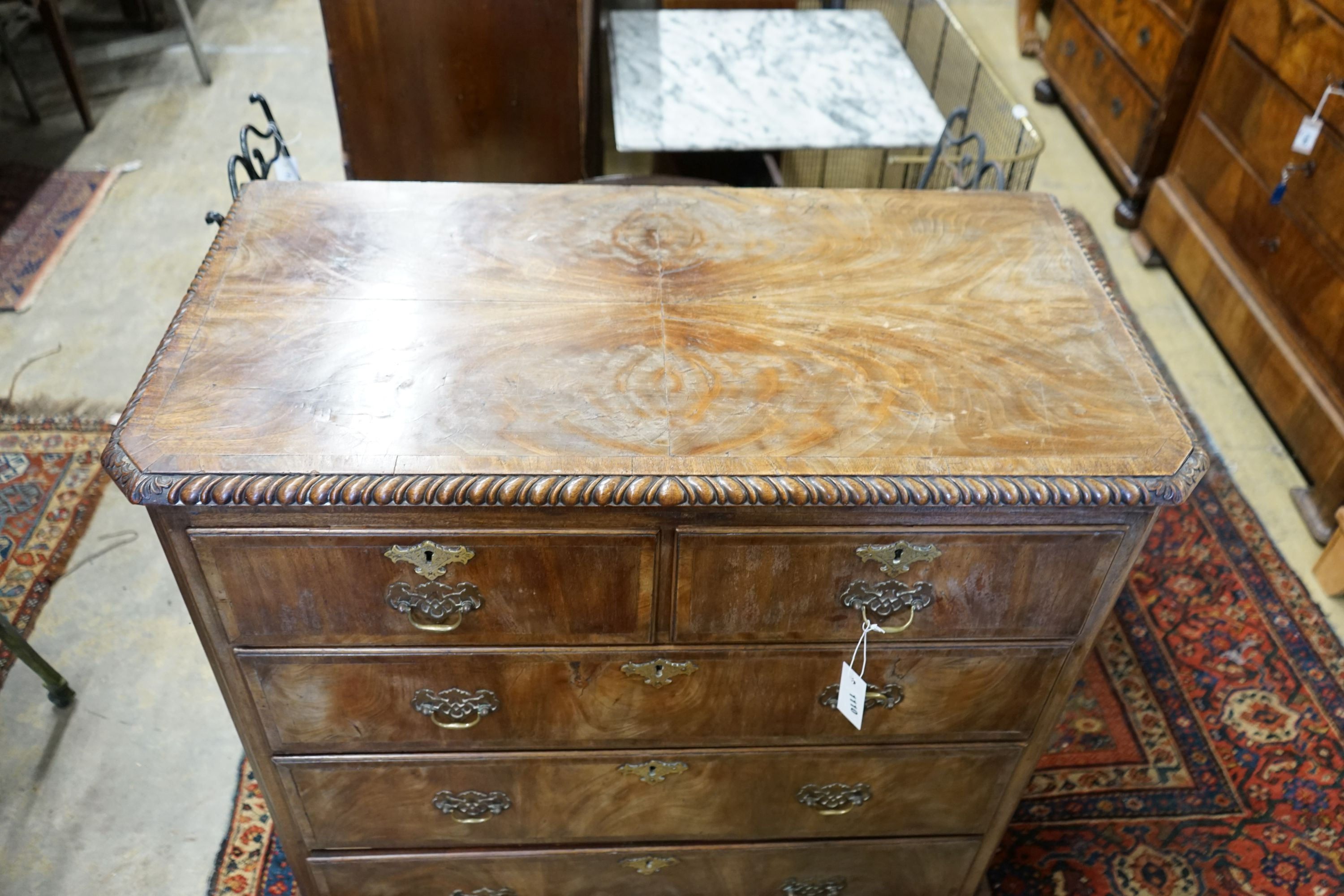 A George II style walnut chest with gadrooned top, width 98cm, depth 51cm, height 98cm